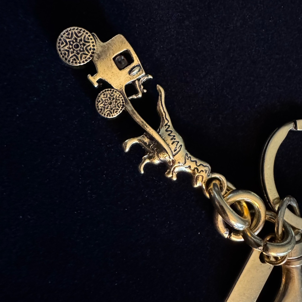 dinosaur pulling a carriage keychain pendant, bag pendant